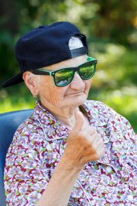 Senior woman wearing sunglasses and baseball cap